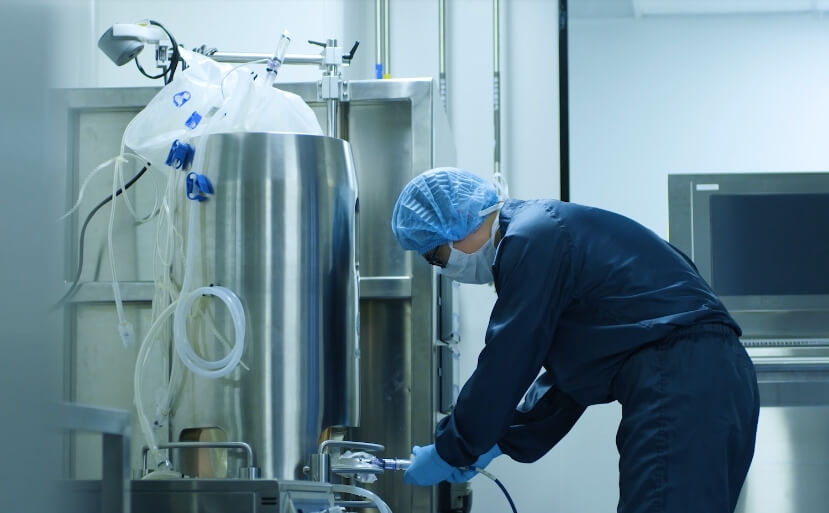 A man in a lab setting up a machine. A man in a lab setting up a machine.